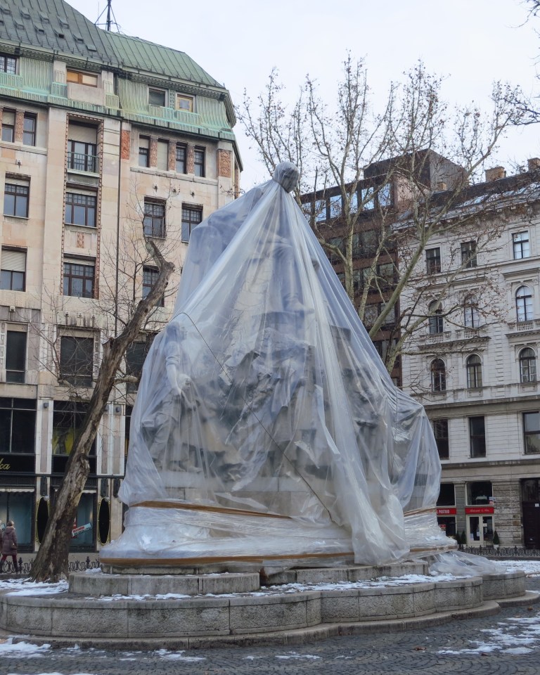 protected & chocked statue on the Vörösmarty square