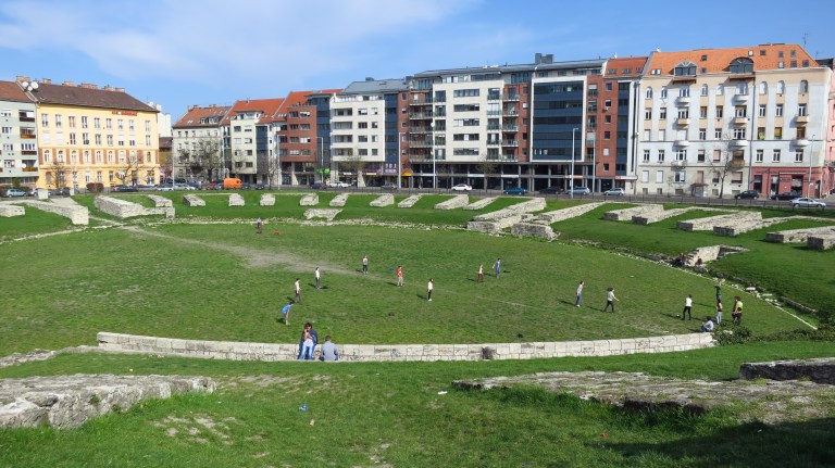 The local youth is playing baseball, where romans were playing as well, twothousand years ago